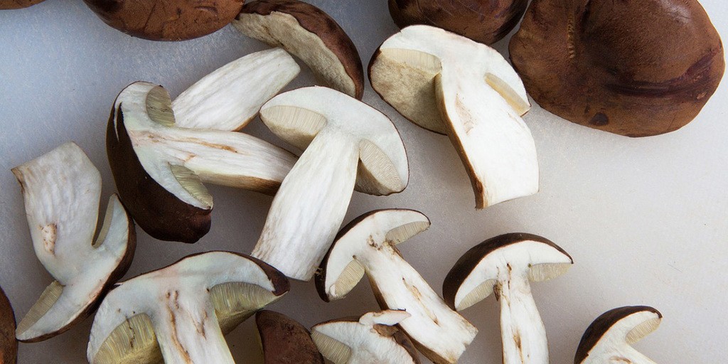 use a knife to cut larger mushrooms into halves, quarters, or slices