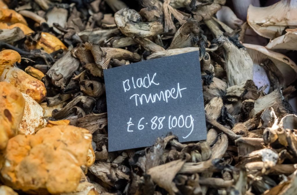 Black trumpet mushrooms for sale at a farmers market
