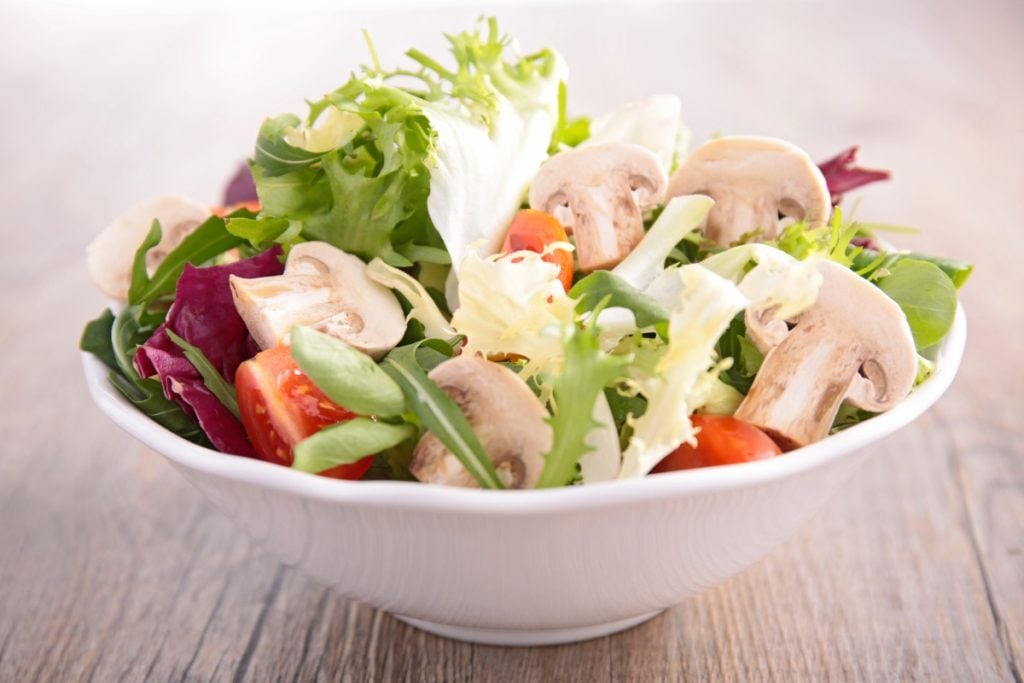 Raw button mushrooms in a salad