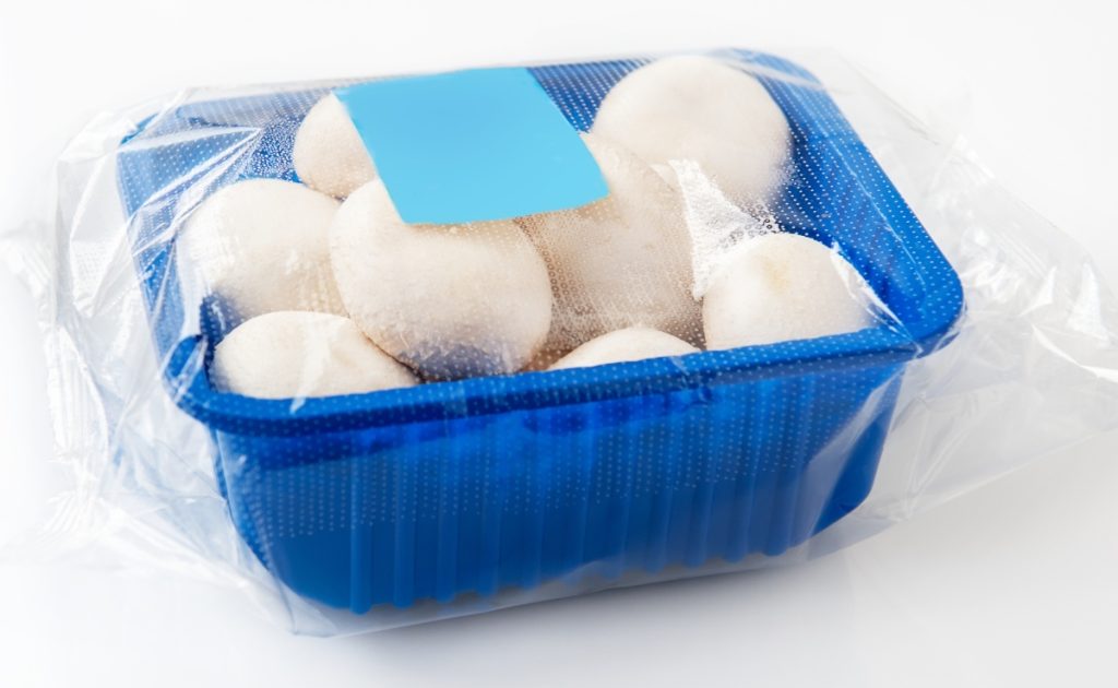Mushrooms packaged with micro-perforated plastic to help the mushrooms last longer.