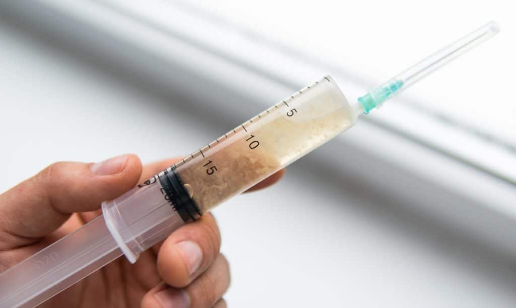 A syringe containing liquid culture for growing mushrooms